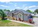 A single-story house with a landscaped yard, stone-accented features, and a neutral exterior paint at 2032 Indian Sky Cir, Lakeland, FL 33813