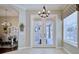 Foyer featuring double doors, natural light, and elegant chandelier at 2032 Indian Sky Cir, Lakeland, FL 33813