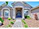 Inviting front entrance with stone accents, a paved walkway and freshly mulched landscaping at 2032 Indian Sky Cir, Lakeland, FL 33813