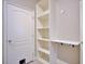 Hallway view with a built-in shelving unit and pull-down desk at 2032 Indian Sky Cir, Lakeland, FL 33813