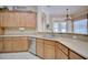 The kitchen features wooden cabinets, stainless steel appliances, and tile flooring at 2032 Indian Sky Cir, Lakeland, FL 33813