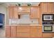 This kitchen includes wooden cabinets, a tile backsplash, and modern appliances at 2032 Indian Sky Cir, Lakeland, FL 33813