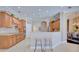 Spacious kitchen featuring wooden cabinetry, an island with seating, and modern appliances at 2032 Indian Sky Cir, Lakeland, FL 33813