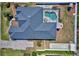 Aerial view of the private pool and backyard, enclosed by a white fence and landscaping at 2032 Indian Sky Cir, Lakeland, FL 33813
