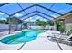 Secluded pool area with screened enclosure and outdoor seating at 2032 Indian Sky Cir, Lakeland, FL 33813