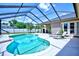 Sparkling pool with a screened-in enclosure and relaxing lounge area at 2032 Indian Sky Cir, Lakeland, FL 33813