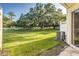 Lush backyard featuring a mature tree draped in Spanish moss and an encompassing white fence at 2047 Winterset Dr, Lakeland, FL 33813
