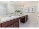 Bathroom with dual sinks, vanity with ample storage, large mirror, and walk-in shower at 2047 Winterset Dr, Lakeland, FL 33813