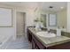 Well-lit bathroom features double sinks, ample counter space, and a decorative rug at 2047 Winterset Dr, Lakeland, FL 33813
