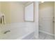 Relaxing bathroom showcasing a large soaking tub with white tile surround and private toilet room at 2047 Winterset Dr, Lakeland, FL 33813