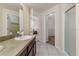 Bright bathroom boasts tiled floors, spacious vanity, walk-in shower, and access to the walk-in closet at 2047 Winterset Dr, Lakeland, FL 33813