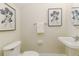 Powder room with pedestal sink and framed floral prints at 2047 Winterset Dr, Lakeland, FL 33813