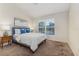 Bright bedroom with a large window, providing natural light, complemented by stylish lamps and decor at 2047 Winterset Dr, Lakeland, FL 33813