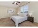 Cozy bedroom featuring neutral tones, vaulted ceiling, and ample natural light from the large window at 2047 Winterset Dr, Lakeland, FL 33813