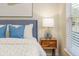 Bedroom featuring a cozy bed with blue accent pillows and side table with soft lighting at 2047 Winterset Dr, Lakeland, FL 33813