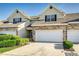 Beautiful townhome featuring a stone facade, attached two-car garage, and manicured landscaping at 2047 Winterset Dr, Lakeland, FL 33813