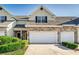 Charming townhome featuring a stone facade, attached two-car garage, and well-maintained landscaping at 2047 Winterset Dr, Lakeland, FL 33813