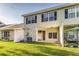 Back exterior of the home with sliding glass doors, well-maintained yard, patio and outdoor seating area at 2047 Winterset Dr, Lakeland, FL 33813