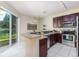 Bright eat-in kitchen featuring stainless steel appliances and sliding glass door to backyard at 2047 Winterset Dr, Lakeland, FL 33813