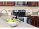 Kitchen with stainless steel appliances, dark wood cabinets, and modern faucet at 2047 Winterset Dr, Lakeland, FL 33813