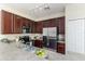 Modern kitchen with dark wood cabinets, stainless steel appliances and track lighting at 2047 Winterset Dr, Lakeland, FL 33813