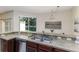 Well-lit kitchen features a stainless steel sink and a view of the backyard at 2047 Winterset Dr, Lakeland, FL 33813