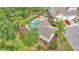 Community pool surrounded by lounge chairs, palm trees, and lush landscaping, offering a resort-style experience at 2047 Winterset Dr, Lakeland, FL 33813