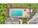 Aerial shot of the community pool showcasing its inviting blue water and comfortable lounge chairs at 2047 Winterset Dr, Lakeland, FL 33813