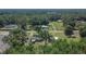 Aerial view showing the placement of the home, outbuildings, and surrounding trees and landscape at 2145 Limedale Rd, Lakeland, FL 33809