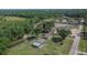 High aerial shot showing the property and surrounding area with mature trees and open fields at 2145 Limedale Rd, Lakeland, FL 33809