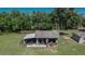 Aerial view of a spacious garage and workshop area, set amidst lush greenery and mature trees at 2145 Limedale Rd, Lakeland, FL 33809