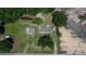 A distant aerial perspective showing outbuildings, a camper, the long driveway, and surrounding land at 2145 Limedale Rd, Lakeland, FL 33809