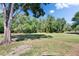 Large backyard with mature trees providing shade and privacy at 2145 Limedale Rd, Lakeland, FL 33809