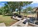 Expansive backyard featuring a grill station, a fire pit, and ample seating for outdoor gatherings at 2145 Limedale Rd, Lakeland, FL 33809