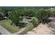 Exterior view of home with fenced-in yard, mature trees, and gravel driveway at 2145 Limedale Rd, Lakeland, FL 33809