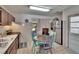 Well-lit eat-in kitchen with stainless appliances, vintage accents, and outdoor views at 2145 Limedale Rd, Lakeland, FL 33809