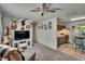 Cozy living room featuring carpet, ceiling fan, and quirky deer head decor at 2145 Limedale Rd, Lakeland, FL 33809