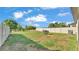 The spacious backyard has a full fence, green grass, and plenty of room for outdoor activities at 2293 Caspian Dr, Lakeland, FL 33805