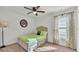 Bedroom with neutral carpet, window with blinds, and a bed with a floral print curtain at 2293 Caspian Dr, Lakeland, FL 33805