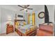 Bright bedroom with a ceiling fan, natural light, matching nightstands, and stylish yellow decor at 2293 Caspian Dr, Lakeland, FL 33805