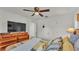Bedroom with dark wood furniture, ceiling fan, and a view into an adjoining room at 2293 Caspian Dr, Lakeland, FL 33805