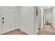 Hallway with wood-look vinyl flooring and white walls leading to multiple rooms in the house at 2293 Caspian Dr, Lakeland, FL 33805