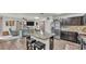 A modern kitchen boasts stainless appliances, granite counters, island, and bar seating at 2293 Caspian Dr, Lakeland, FL 33805