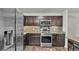Modern kitchen with stainless steel appliances, dark wood cabinets, and stylish backsplash at 2293 Caspian Dr, Lakeland, FL 33805