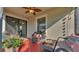 The screened lanai has a ceiling fan, wicker furniture, and overlooks the beautiful backyard at 2293 Caspian Dr, Lakeland, FL 33805
