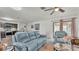 Bright living room showcases comfortable furniture, a ceiling fan, and views into the kitchen at 2293 Caspian Dr, Lakeland, FL 33805