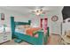 A vibrant main bedroom features a unique teal bed frame and ample natural light at 2293 Caspian Dr, Lakeland, FL 33805