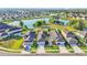 Aerial view of beautiful single-Gathering homes, front lawns, and community lake at 2293 Caspian Dr, Lakeland, FL 33805