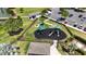 Aerial view of fenced-in neighborhood playground area with picnic tables and small play equipment at 2293 Caspian Dr, Lakeland, FL 33805