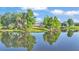 The house overlooks a lovely pond with mature trees and serene water views at 2293 Caspian Dr, Lakeland, FL 33805
